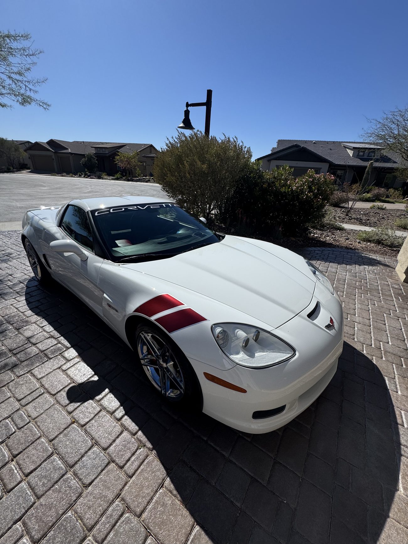 Detailed white Corvette with a red racing stripe