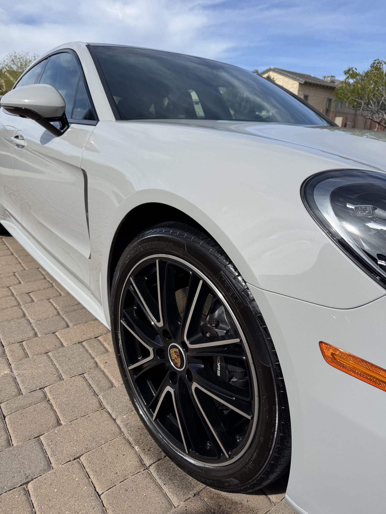 Detailed white Porsche Panamera with polished black wheels