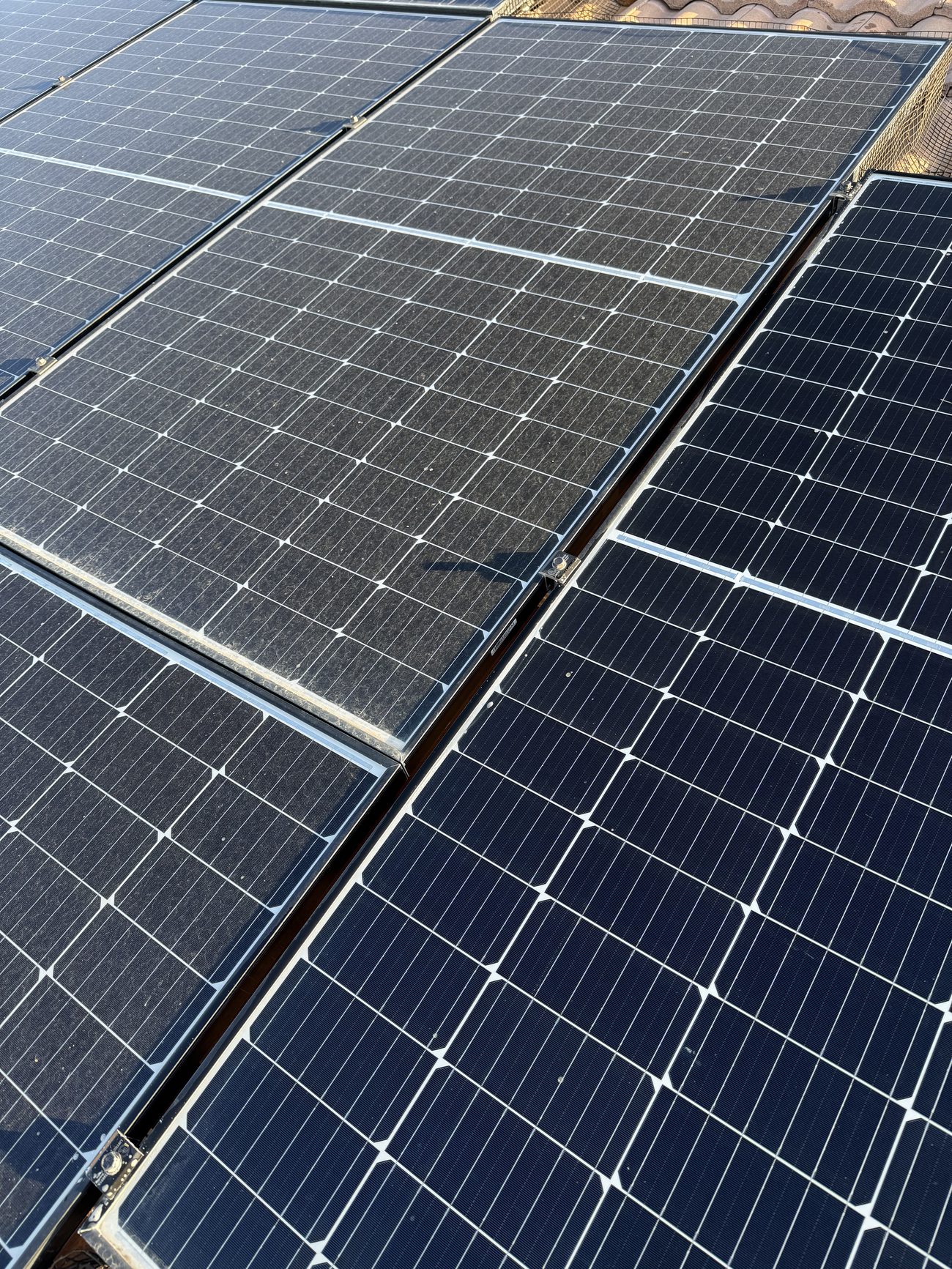 Close-up of clean, streak-free solar panels on a tile roof