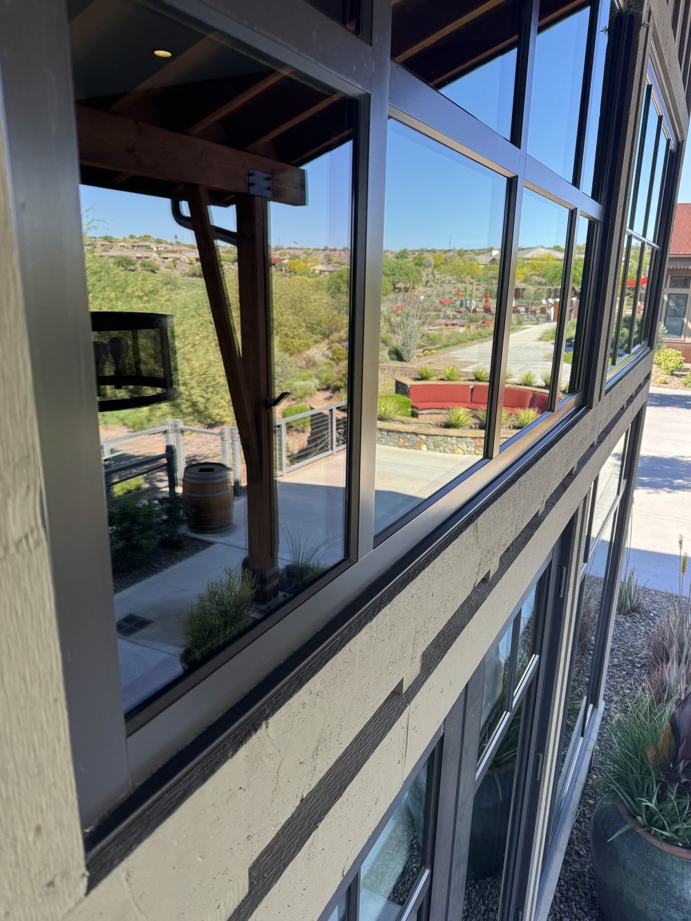 Crystal-clear residential window with a sharp mountain reflection after cleaning